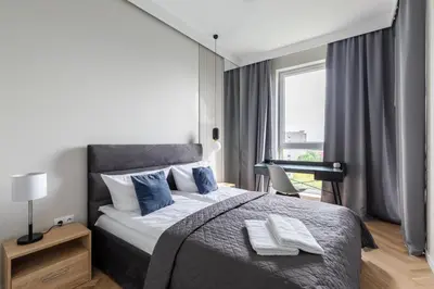Łóżko lub łóżka w pokoju w obiekcie Zoliborz Rydygiera P&O Serviced Apartments