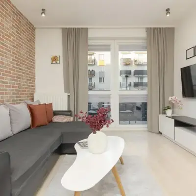 Subtle Colors Apartment in Warsaw with Furnished Balcony by Noclegi Renters