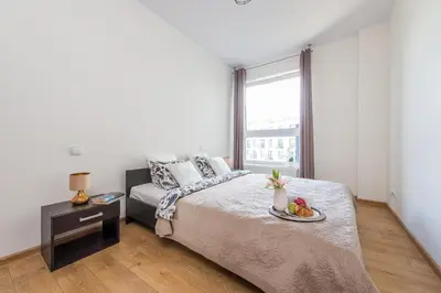 Łóżko lub łóżka w pokoju w obiekcie P&O Apartments Wola Tarasy