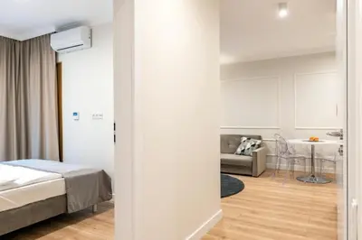 Łóżko lub łóżka w pokoju w obiekcie Mennica Residence