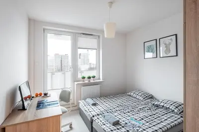 Łóżko lub łóżka w pokoju w obiekcie Waw Pokoje Manhattan